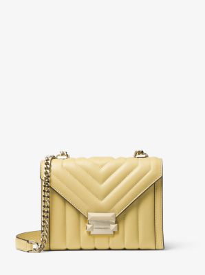 Truffle shoulder bag with gold hardware and chain strap in black