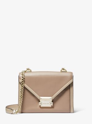 Truffle shoulder bag with gold hardware and chain strap in black