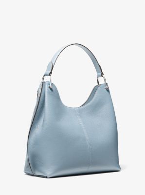 Grand sac &agrave; &eacute;paule Joan en su&egrave;de perfor&eacute; &agrave; logo