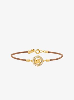 Pulsera de cord&oacute;n con logotipo e incrustaciones de pav&eacute; en tono dorado